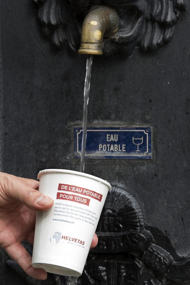 Drinking water is poured into a cup