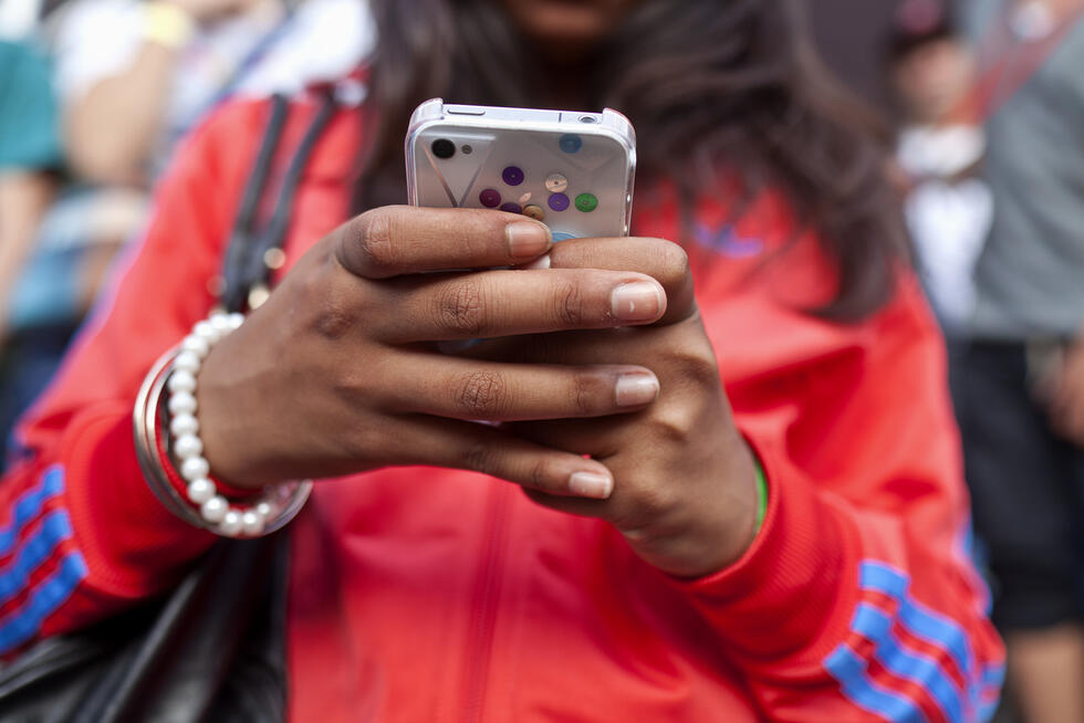 a woman using her smartphone while walking